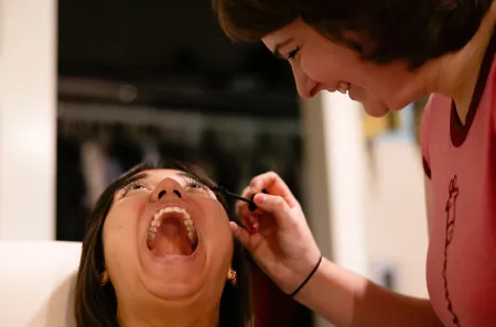 In another photo from Towle's winning series, Kaelyn Brooker applies mascara to Denise Waddell, doing the “mascara face,” in her home on Friday, Oct. 13, 2023, in Frankfort, Kentucky.