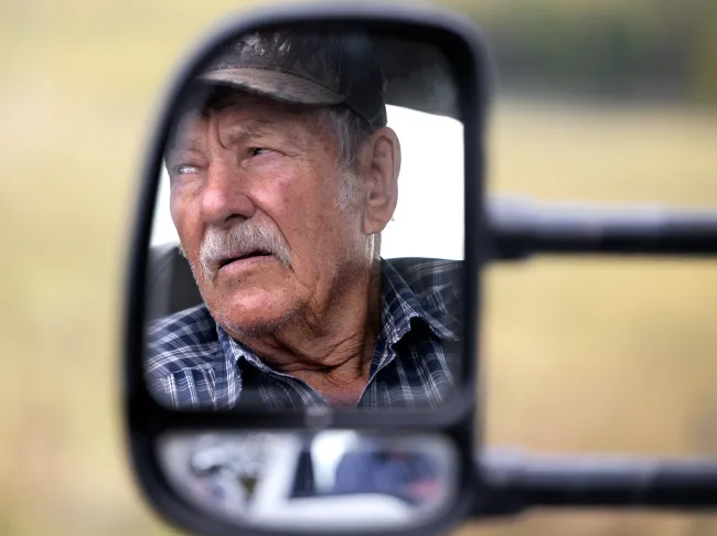 Martin Henson looks out his window as he pulls a trailer of hay behind him, on Friday Oct. 13, 2023, in Franklin County, Kentucky. Photo by Matthew Mueller.