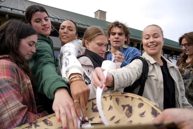 University of Kentucky journalism students draw their story leads out of a hat at the launch of the Picture Kentucky Photojournalism Workshop in Frankfort, Ky., on Oct. 11, 2023. Photo by Carter Skaggs.
