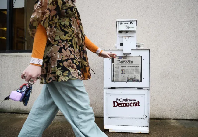 Cynthiana Democrat Regional Editor Kendall Staton walks by a newspaper stand on Tuesday, Jan. 23, 2024, outside of the Democrat office in Cynthiana, Kentucky. Staton is one of the youngest newspaper editor’s in the country. Photo by Abbey Cutrer.