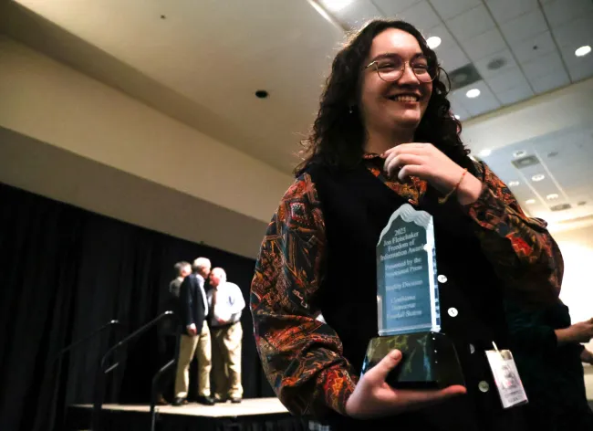 Cynthiana Democrat Regional Editor Kendall Staton accepts her Jon Fleischaker Freedom of Information Award during the Kentucky Press Association Awards on Friday, Jan. 26, 2024, at the Holiday Inn University Plaza in Bowling Green, Kentucky. The Fleischaker Award is given to journalists who demonstrate exceptional use of public records for reporting. Staton won this award less than a year after graduating college. Photo by Abbey Cutrer.