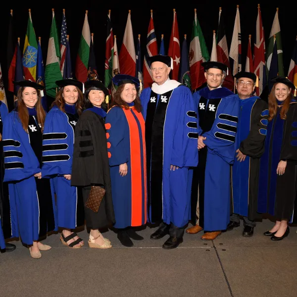 W. Lawrence Patrick (center) shown with (from left to right): UK President Eii Capilouto, Sarah Geegan, Liz Spencer, Deborah Chung, UK Provost Robert DiPaola, Zixue Tai, Brandi Frisby and Erin Hester after receiving his honorary doctorate at the May 2023 commencement ceremony.