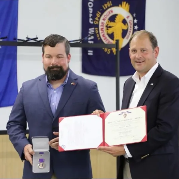 This September, CI doctoral student and veteran Joey Bates, left, was presented the Purple Heart medal by U.S. Rep. Andy Barr. Photo provided.